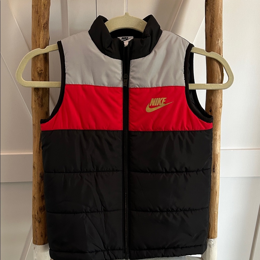 Nike Black and Red Puffer Vest with Gold Emblem. Boys 6-7 yrs.
